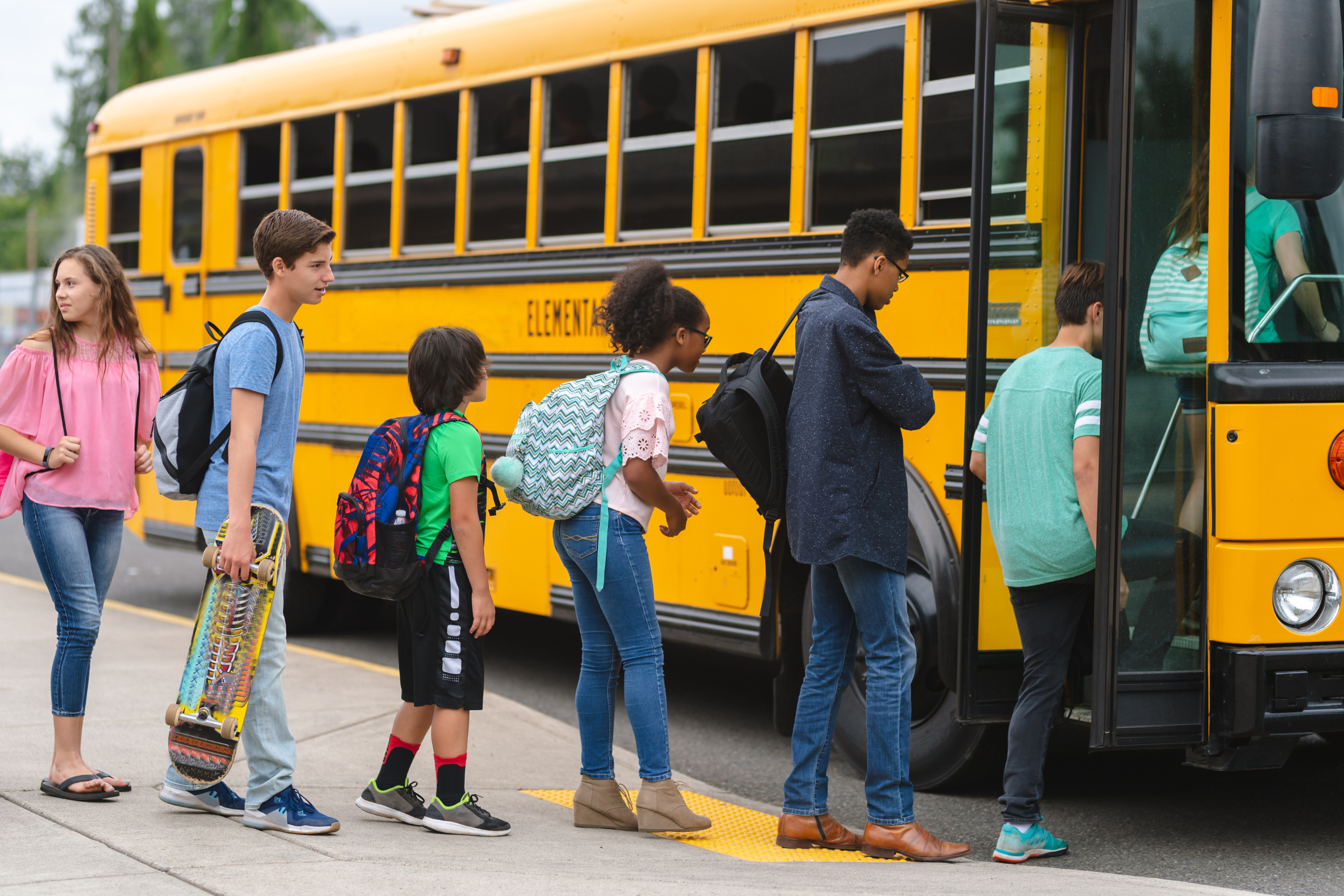 children safely loading school bus
