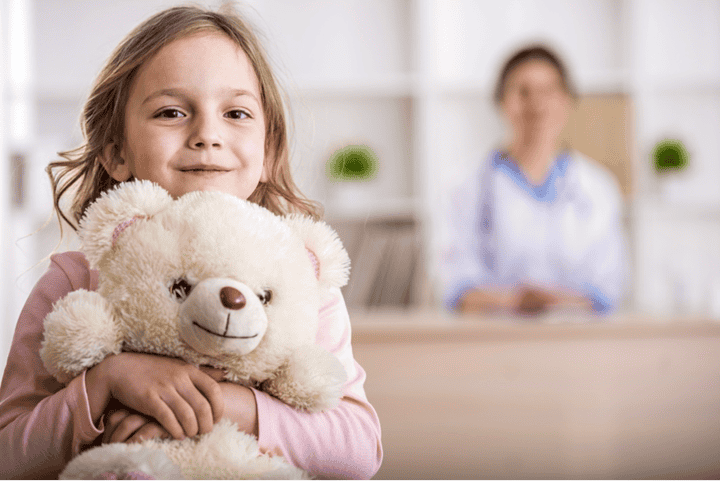 little girl holding stuffed bear